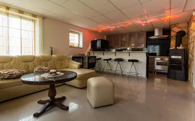a living room with a couch and a table at Raigardo in Druskininkai