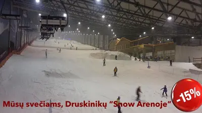 a group of people skiing down a snow covered slope at Raigardo in Druskininkai