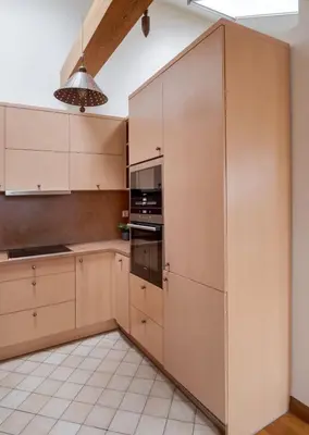 a kitchen with white cabinets and a ceiling at Cosy Place in Old Town in Vilnius