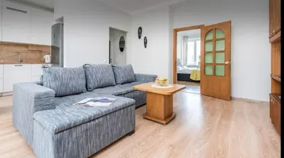 a living room with a couch and a table at Warm and Timeless- Authentic Vintage Living in Paupys in Vilnius
