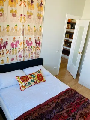 a bedroom with a bed with a pillow on it at Warm and Timeless- Authentic Vintage Living in Paupys in Vilnius