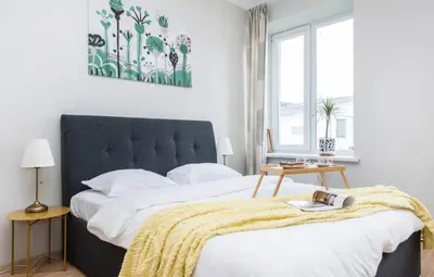 a bedroom with a large bed with a yellow blanket at Warm and Timeless- Authentic Vintage Living in Paupys in Vilnius