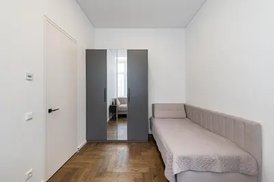 a white bedroom with a bed and a mirror at Vytauto 43 Residence 6 by Domvia in Kaunas