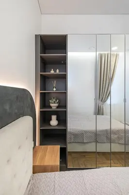 a bedroom with a bed and a glass cabinet at Vytauto 43 Residence 6 by Domvia in Kaunas