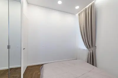 a bedroom with white walls and a bed and a window at Vytauto 43 Residence 6 by Domvia in Kaunas