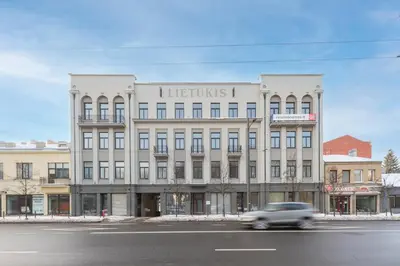 a car driving down a street in front of a building at Vytauto 43 Residence 6 by Domvia in Kaunas