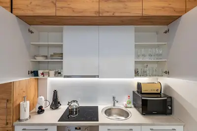 a kitchen with a sink and a microwave at Center apartment by Polo Apartments in Kaunas