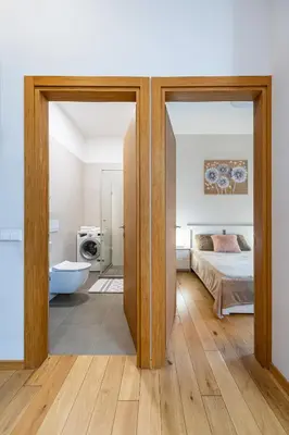 an open door to a bedroom with a bed and a tub at Center apartment by Polo Apartments in Kaunas