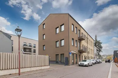 a building on a street with cars parked on the street at Center apartment by Polo Apartments in Kaunas