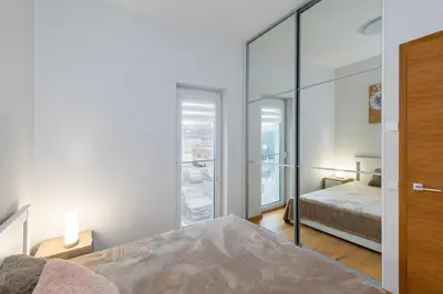 a bedroom with a bed and a mirror at Center apartment by Polo Apartments in Kaunas