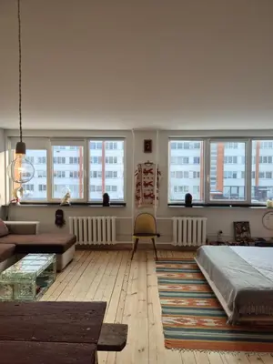 a living room with many windows and a couch at Nordhouse in Šiauliai