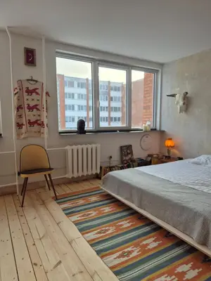 a bedroom with a bed and a large window at Nordhouse in Šiauliai
