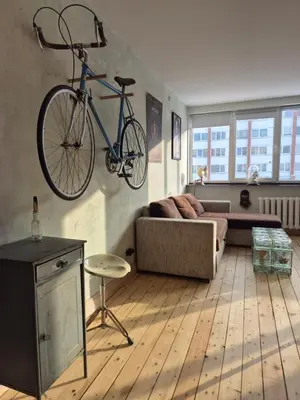 a living room with a bike hanging on the wall at Nordhouse in Šiauliai