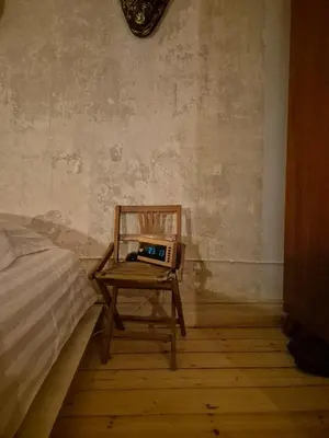 a chair with a laptop on it in a bedroom at Nordhouse in Šiauliai