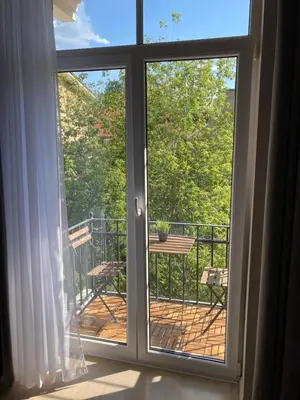 a sliding glass door with a view of a balcony at Old Town Riverside Cathedral Apartment in Vilnius