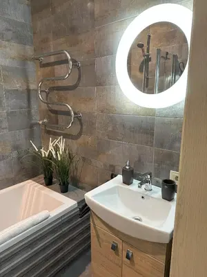 a bathroom with a sink and a mirror at Old Town Riverside Cathedral Apartment in Vilnius
