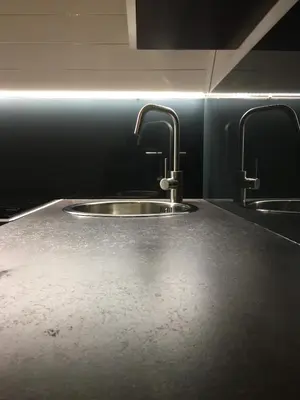 a kitchen with two sinks and two faucets at Cozy and quiet apartment near the city in Kaunas