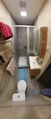 a bathroom with a shower and a toilet and a sink at Valdau NT in Kaunas