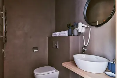 a bathroom with a sink and a toilet and a mirror at Barono Vila in Butėnai