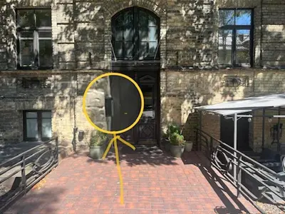 a yellow mirror sitting in front of a building at Green apple - Self check-in - Free parking in Vilnius