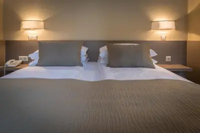 a bedroom with a large bed with two pillows at Green apple - Self check-in - Free parking in Vilnius