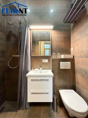 a bathroom with a sink and a toilet and a shower at Green apple - Self check-in - Free parking in Vilnius