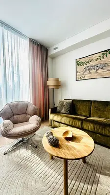 a living room with a couch and a coffee table at Cozy Riverside Apartment in Birštonas