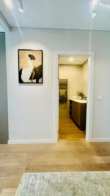 a white room with a painting on the wall at Cozy Riverside Apartment in Birštonas