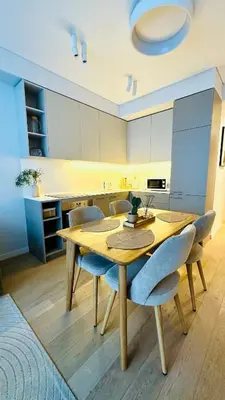 a dining room with a wooden table and chairs at Cozy Riverside Apartment in Birštonas