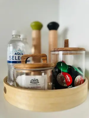 a wooden container filled with food and a jar of cherries at Cozy Riverside Apartment in Birštonas
