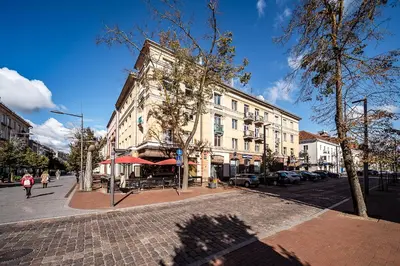 a building on the corner of a city street at Guido apartament in Šiauliai