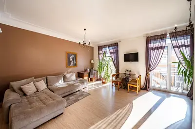 a living room with a couch and a table at Guido apartament in Šiauliai