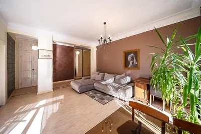 a living room with a couch and a potted plant at Guido apartament in Šiauliai