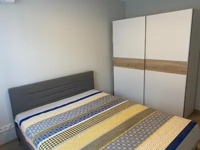 a bedroom with a bed and a cabinet at Čiurlionio 5 in Druskininkai