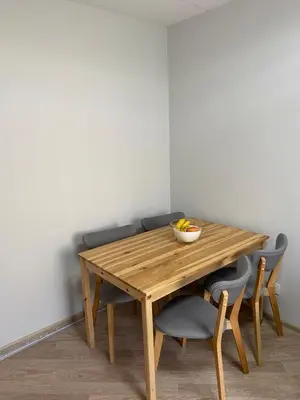 a wooden table with chairs and a bowl of fruit on it at Čiurlionio 5 in Druskininkai