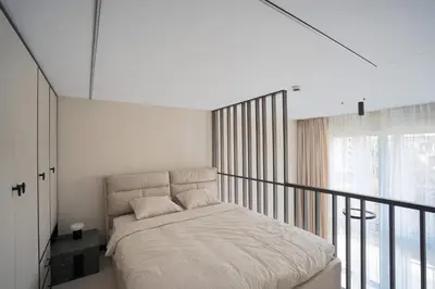 a white bedroom with a bed on a balcony at Vilnius Luxury Appartement in Vilnius