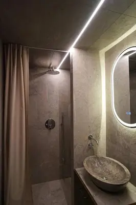 a bathroom with a sink and a shower with a mirror at Vilnius Luxury Appartement in Vilnius