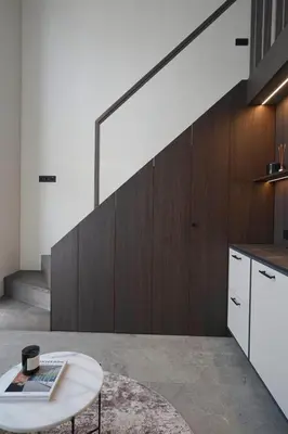 a living room with a table and a staircase at Vilnius Luxury Appartement in Vilnius