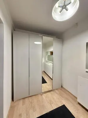 a room with a sliding door with a mirror at Domillion 1bdr Quiet City Hall apt D1115 in Vilnius