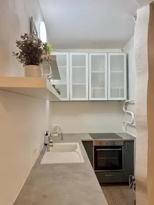 a kitchen with white cabinets and a sink at Domillion 1bdr Quiet City Hall apt D1115 in Vilnius
