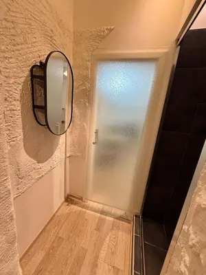 a mirror on a wall next to a door at Domillion 1bdr Quiet City Hall apt D1115 in Vilnius