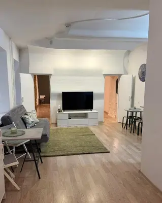 a living room with a couch and a flat screen tv at Domillion 1bdr Quiet City Hall apt D1115 in Vilnius