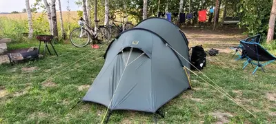 a tent sitting on the grass in a field at Vigio Brasta camping in Elektrėnai