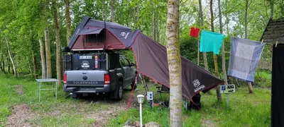 a jeep with a tent on the back of it at Vigio Brasta camping in Elektrėnai