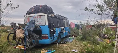 a bus with a bike parked in front of it at Vigio Brasta camping in Elektrėnai