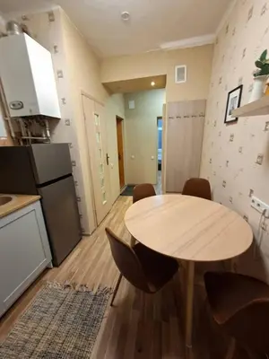 a kitchen with a table and chairs in a room at Aguona namai apartamentai in Kaunas