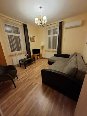 a living room with a couch and a television at Aguona namai apartamentai in Kaunas