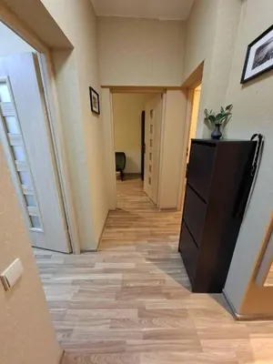 a hallway with a room with a television and a hallwayngthngthngthngthngth at Aguona namai apartamentai in Kaunas