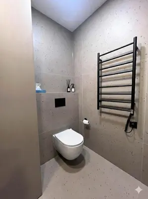 a bathroom with a white toilet in a room at New Cozy Designer Apartment in Uzupis Walk to Old Town in a Luxury Building Garden View Balcony in Vilnius