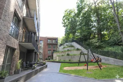 a playground in a courtyard next to a building at New Cozy Designer Apartment in Uzupis Walk to Old Town in a Luxury Building Garden View Balcony in Vilnius